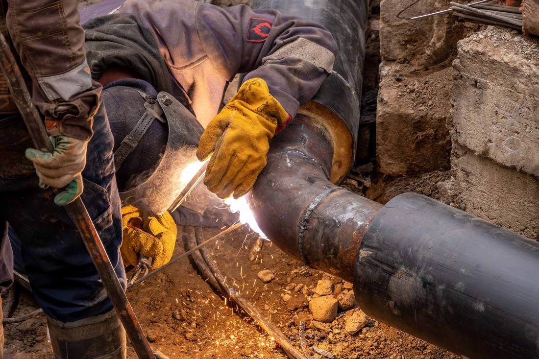 Welding a section of underground pipe